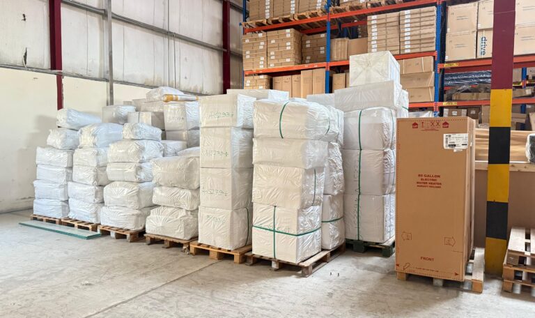 "Packed cargo pallets and wooden crates prepared for shipment inside a warehouse, showcasing organized cargo logistics in Qatar and professional freight handling."